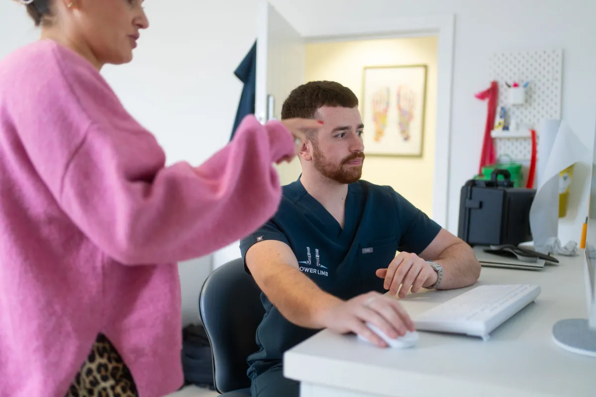 Podiatry consultation at a clinic desk